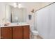 Bright bathroom with cherry cabinets, white tile, and decorative turtle art at 7328 Caversham Way, Raleigh, NC 27617