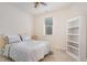 Well-lit bedroom with a queen-sized bed, natural light, and an open bookcase at 7328 Caversham Way, Raleigh, NC 27617