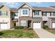 Inviting townhome featuring a one-car garage and well maintained landscaping at 7328 Caversham Way, Raleigh, NC 27617