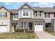 Charming townhomes with brick accents, individual garages, and well-maintained landscaping offering curb appeal and convenience at 7328 Caversham Way, Raleigh, NC 27617