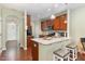 Open kitchen layout with breakfast bar and stainless steel appliances at 7328 Caversham Way, Raleigh, NC 27617
