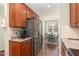 Kitchen with stainless steel appliances, wood cabinets, and view to dining area at 7328 Caversham Way, Raleigh, NC 27617