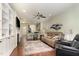 Comfortable living area featuring fireplace, ceiling fan, and open floor plan at 7328 Caversham Way, Raleigh, NC 27617