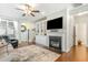 Inviting living room featuring fireplace, built-ins, and ceiling fan at 7328 Caversham Way, Raleigh, NC 27617