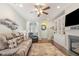 Comfortable living room with ceiling fan, fireplace, and large sofa, perfect for relaxing and entertaining at 7328 Caversham Way, Raleigh, NC 27617