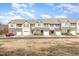 Street view of attractive townhouses with varying colors, garages and neat landscaping at 7328 Caversham Way, Raleigh, NC 27617