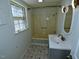 Bathroom with tile floors, natural light and a shower tub combo at 7702 Nc Highway 581, Kenly, NC 27542