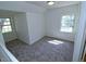 Bright bedroom featuring new carpet and two windows at 7702 Nc Highway 581, Kenly, NC 27542