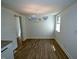Dining area with modern light fixture and LVP flooring, adjacent to kitchen at 7702 Nc Highway 581, Kenly, NC 27542