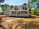 Quaint home featuring a white picket fence, dormer windows and detached garage at 7702 Nc Highway 581, Kenly, NC 27542