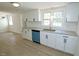 Bright, remodeled kitchen with stainless steel sink and sleek white cabinets at 7702 Nc Highway 581, Kenly, NC 27542