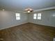 A large open living room with ample light, featuring luxury vinyl plank flooring at 7702 Nc Highway 581, Kenly, NC 27542
