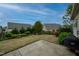 Backyard featuring a patio, lawn, trees, and an iron fence at 833 Gaston Manor Dr, Durham, NC 27703