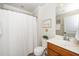 Clean bathroom featuring a shower with white curtain, white toilet, and a wood vanity with sink at 833 Gaston Manor Dr, Durham, NC 27703