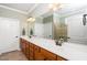Well-lit bathroom boasts a long vanity with dual sinks, neutral color scheme, and walk-in shower at 833 Gaston Manor Dr, Durham, NC 27703