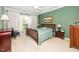 Serene bedroom featuring a comfortable bed, soft green walls, and a picturesque view from the bright window at 833 Gaston Manor Dr, Durham, NC 27703