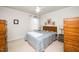 Cozy bedroom with soft carpet, a large bed with blue patterned bedding, and wooden bedside tables at 833 Gaston Manor Dr, Durham, NC 27703