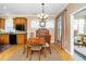 Bright dining area showcases hardwood floors, a wooden table set, and classic decor with lots of natural light at 833 Gaston Manor Dr, Durham, NC 27703