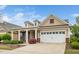 Beautiful home exterior with a covered porch, two-car garage, and well-maintained landscaping at 833 Gaston Manor Dr, Durham, NC 27703