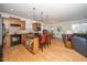 Open-concept kitchen with wood cabinets, an island with bar seating, and an adjoining dining area perfect for entertaining at 833 Gaston Manor Dr, Durham, NC 27703