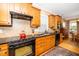 Well-equipped kitchen with a black range oven, granite countertops, and ample cabinet space at 833 Gaston Manor Dr, Durham, NC 27703