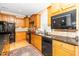 Well-lit kitchen with stainless steel appliances and dark granite countertops at 833 Gaston Manor Dr, Durham, NC 27703