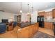 Kitchen island with a granite countertop, cabinet storage, and barstool seating at 833 Gaston Manor Dr, Durham, NC 27703
