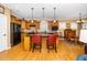 Spacious kitchen featuring a kitchen island with seating and hardwood flooring at 833 Gaston Manor Dr, Durham, NC 27703