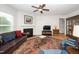 Inviting living room featuring a fireplace, ceiling fan, and comfortable seating with a large decorative rug at 833 Gaston Manor Dr, Durham, NC 27703
