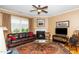 Living room with a fireplace, large window, and a comfortable leather sofa at 833 Gaston Manor Dr, Durham, NC 27703