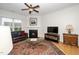 Cozy living room with fireplace, ceiling fan, and comfortable seating area at 833 Gaston Manor Dr, Durham, NC 27703