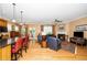 Open-concept living room with hardwood floors, fireplace, and access to an outdoor patio at 833 Gaston Manor Dr, Durham, NC 27703