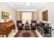Inviting living room with two plush armchairs, an accent rug, and a vintage-style wooden desk at 833 Gaston Manor Dr, Durham, NC 27703