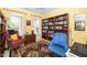 Comfortable living room with large bookshelf, accent rug, and two chairs at 833 Gaston Manor Dr, Durham, NC 27703