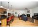 Open concept living space with kitchen island, dining area, and a cozy fireplace at 833 Gaston Manor Dr, Durham, NC 27703