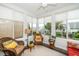 Inviting sunroom filled with natural light, wicker furniture, and views of the well-maintained outdoor space at 833 Gaston Manor Dr, Durham, NC 27703