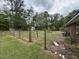 A backyard with a view of the storage shed, surrounded by trees and a barbed wire fence at 8535 Us-301 S Hwy, Four Oaks, NC 27524