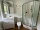 A bright bathroom features a corner shower, vanity and hardwood flooring at 8535 Us-301 S Hwy, Four Oaks, NC 27524