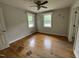 A simple bedroom features hardwood floors, neutral walls, and natural light from the windows at 8535 Us-301 S Hwy, Four Oaks, NC 27524