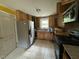 Kitchen featuring wood cabinets, modern appliances, and tile flooring at 8535 Us-301 S Hwy, Four Oaks, NC 27524
