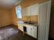 A kitchen features white cabinets and double stainless steel sinks, with a window at 8535 Us-301 S Hwy, Four Oaks, NC 27524