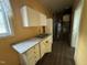 A compact kitchen has white cabinets and a double stainless steel sink at 8535 Us-301 S Hwy, Four Oaks, NC 27524