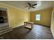 A living room with yellow walls, with access to the kitchen and natural light at 8535 Us-301 S Hwy, Four Oaks, NC 27524
