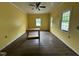 A living room with yellow walls, with natural light coming from the three windows at 8535 Us-301 S Hwy, Four Oaks, NC 27524