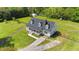Aerial view of a charming home with a lush green lawn and a fenced perimeter at 8700 Crowder Rd, Raleigh, NC 27603