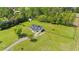 Aerial view of home, driveway, lush lawn, fencing, and mature trees at 8700 Crowder Rd, Raleigh, NC 27603