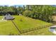 View of the extensive backyard with fencing, mature trees, and an outbuilding at 8700 Crowder Rd, Raleigh, NC 27603