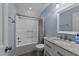 Bathroom with granite counters, tub with shower, and vanity at 8700 Crowder Rd, Raleigh, NC 27603