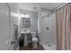 Cozy bathroom features a standing sink, vinyl floors, and a tiled shower with a shower curtain at 8700 Crowder Rd, Raleigh, NC 27603