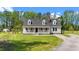 Charming home featuring a welcoming front porch, dormer windows, and a well-maintained front yard at 8700 Crowder Rd, Raleigh, NC 27603